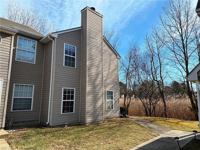 view of side of home featuring a lawn