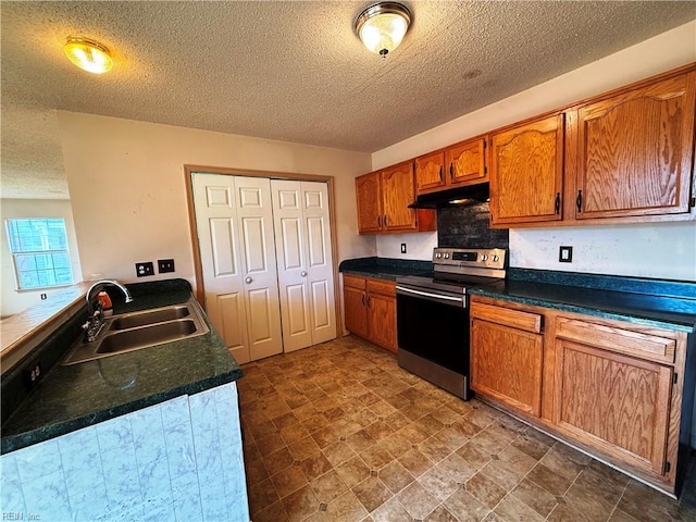 kitchen with sink, a textured ceiling, and electric range