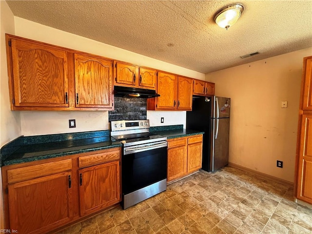 kitchen with stainless steel appliances and a textured ceiling