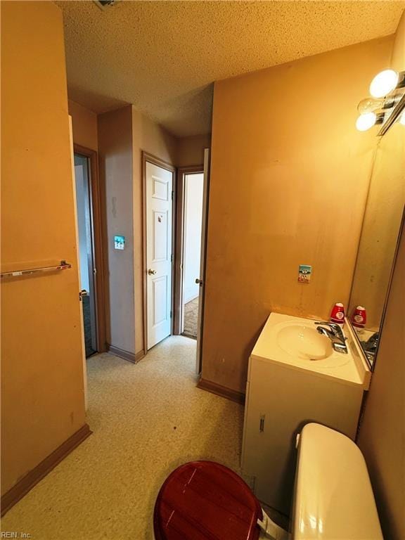 bathroom featuring sink and a textured ceiling