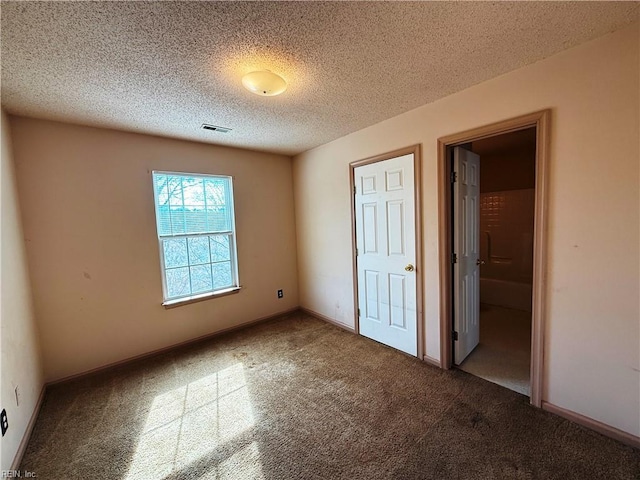 unfurnished bedroom with carpet and a textured ceiling