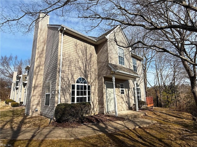 view of side of property featuring a patio area