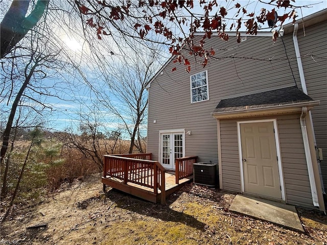 rear view of house with a wooden deck, central AC unit, and french doors