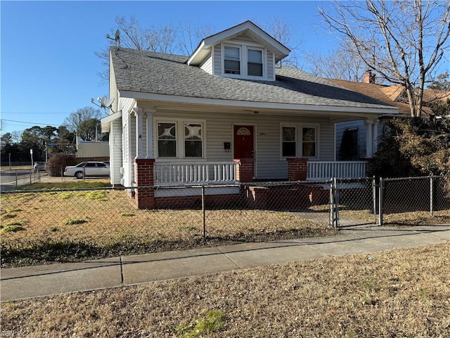 bungalow-style house with covered porch and a front lawn