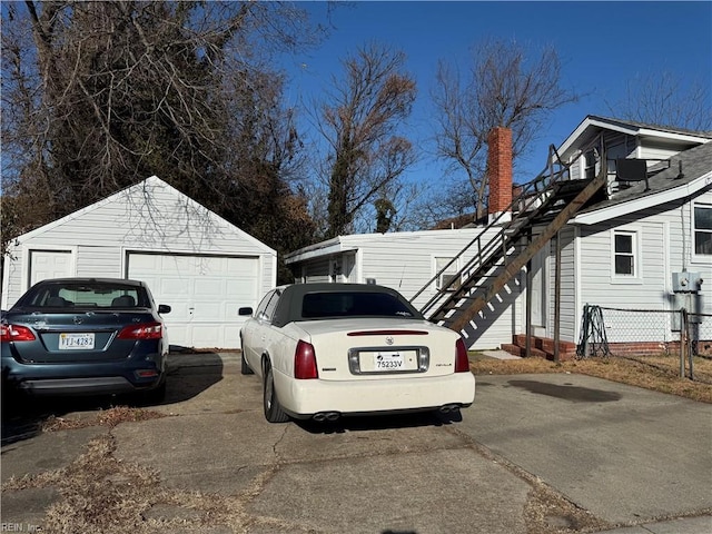 view of property exterior with a garage and an outdoor structure