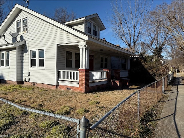 view of side of property with covered porch