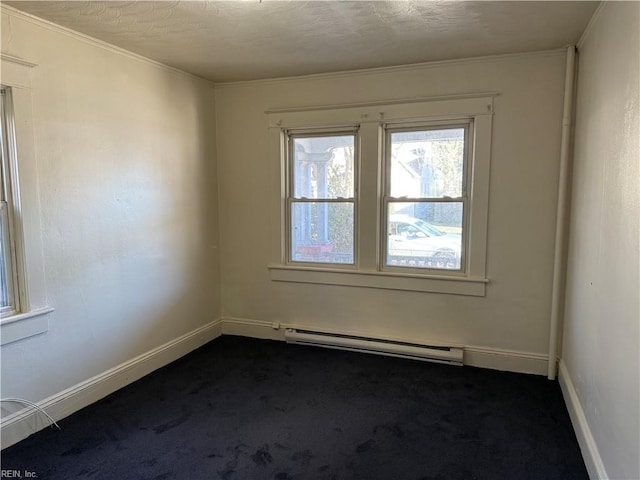 carpeted spare room with a textured ceiling and baseboard heating