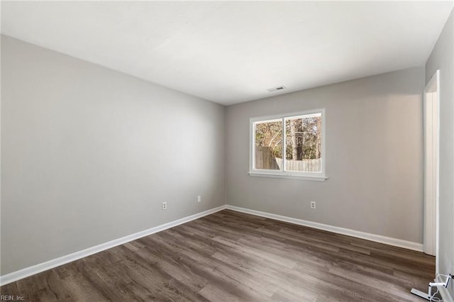 spare room featuring dark wood-type flooring