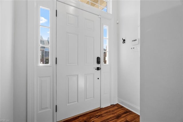 entrance foyer with plenty of natural light and dark hardwood / wood-style floors