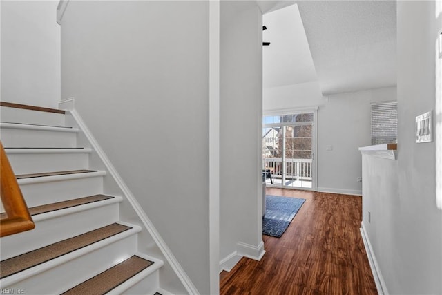 staircase with wood-type flooring