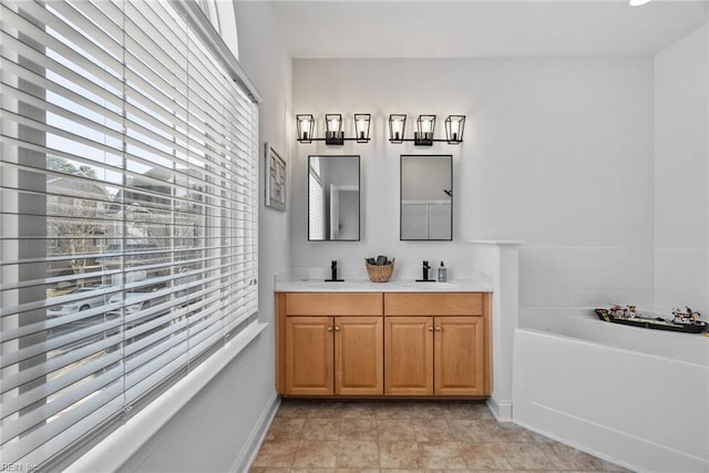 bathroom featuring vanity, a bath, and tile patterned floors