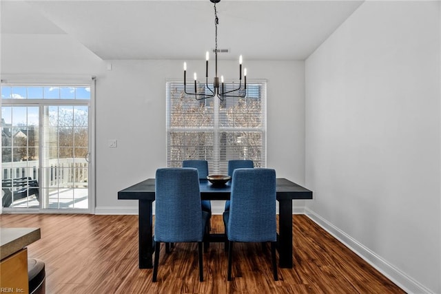 dining area featuring an inviting chandelier and wood-type flooring