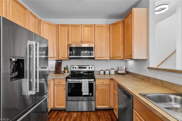 kitchen with light brown cabinetry, sink, dark hardwood / wood-style flooring, and stainless steel appliances