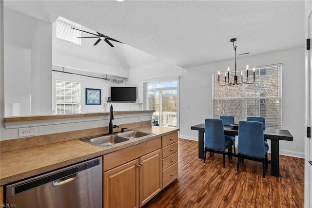 kitchen featuring lofted ceiling, sink, hanging light fixtures, stainless steel dishwasher, and dark hardwood / wood-style floors