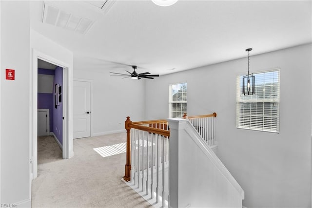 hallway featuring light colored carpet