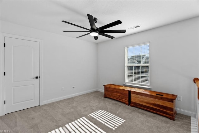 unfurnished bedroom with light colored carpet and ceiling fan