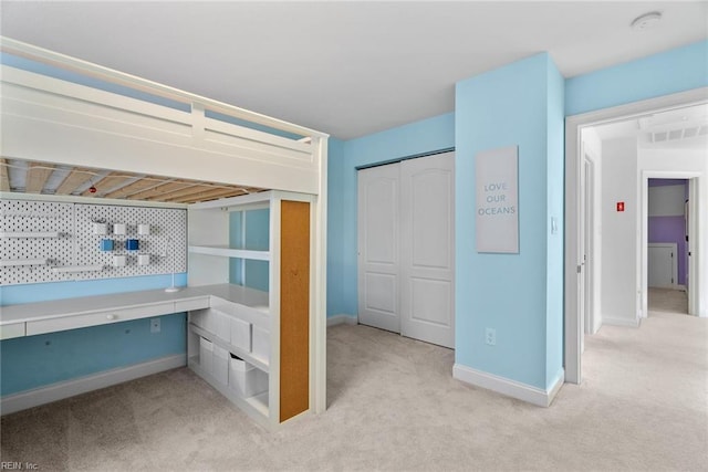 bedroom featuring a closet and light carpet