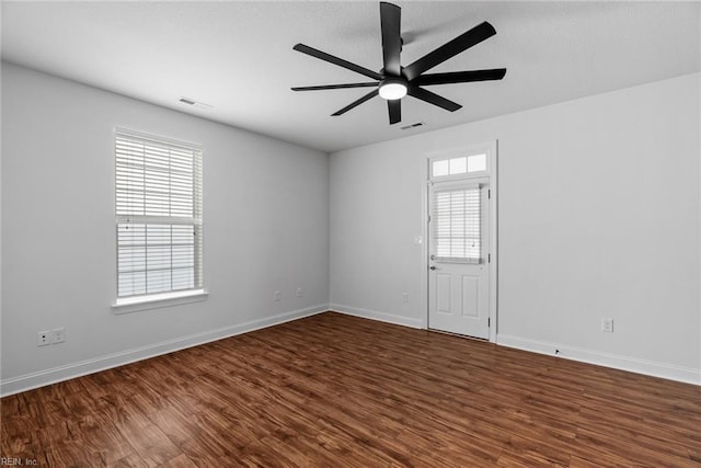 spare room with hardwood / wood-style floors and ceiling fan