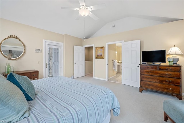 carpeted bedroom with vaulted ceiling, ceiling fan, and ensuite bathroom