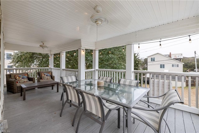 wooden deck with an outdoor hangout area and ceiling fan