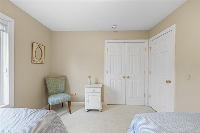 bedroom with light colored carpet and a closet