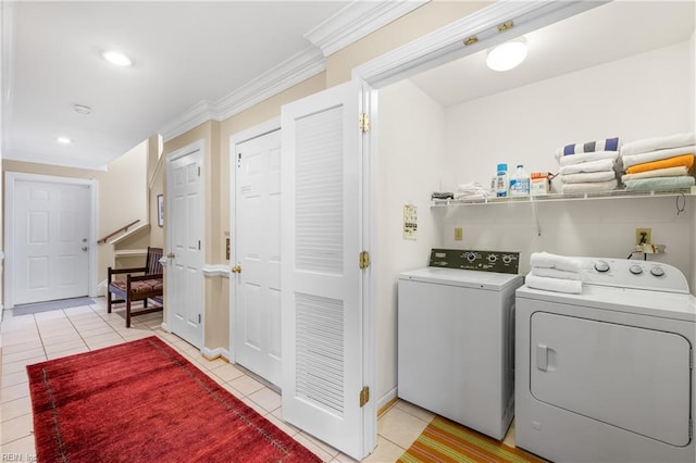 laundry room with light tile patterned floors, crown molding, and washing machine and dryer