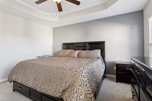 bedroom featuring light carpet, a raised ceiling, and ceiling fan