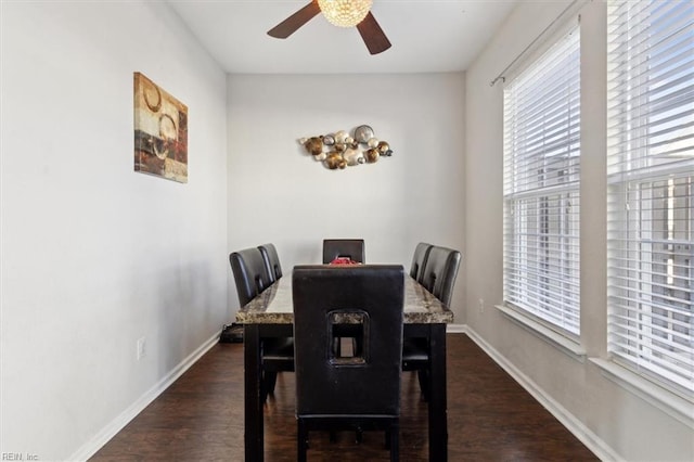 dining space featuring dark wood-type flooring and ceiling fan