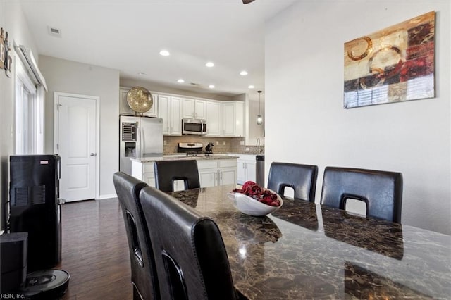 dining room with dark wood-type flooring and sink