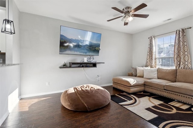 living room featuring ceiling fan and hardwood / wood-style floors