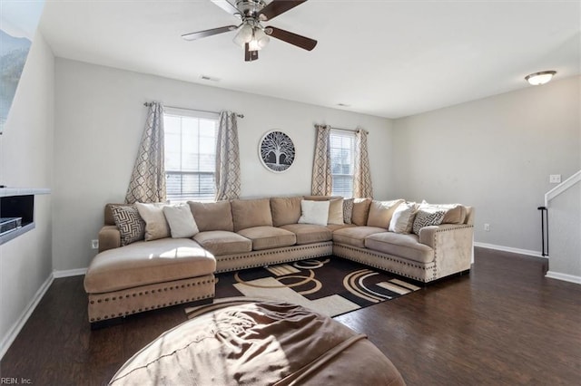 living room featuring dark hardwood / wood-style floors, a wealth of natural light, and ceiling fan