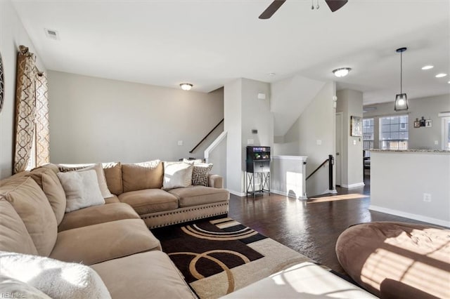 living room featuring dark hardwood / wood-style floors and ceiling fan