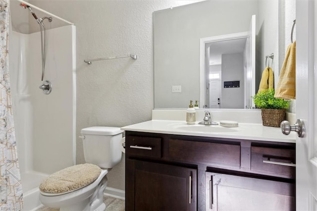 bathroom with vanity, curtained shower, and toilet