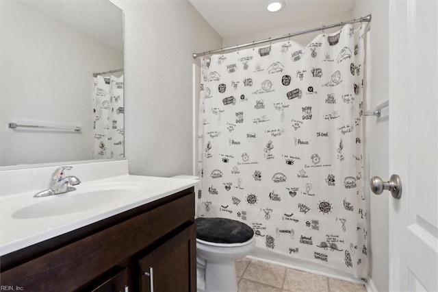 bathroom featuring tile patterned floors, vanity, and toilet