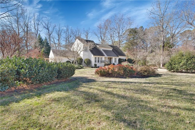 view of side of property with a yard