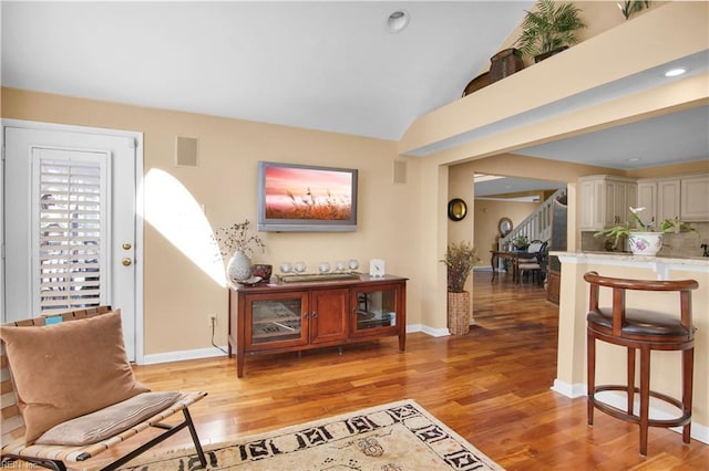 sitting room featuring lofted ceiling and light hardwood / wood-style floors