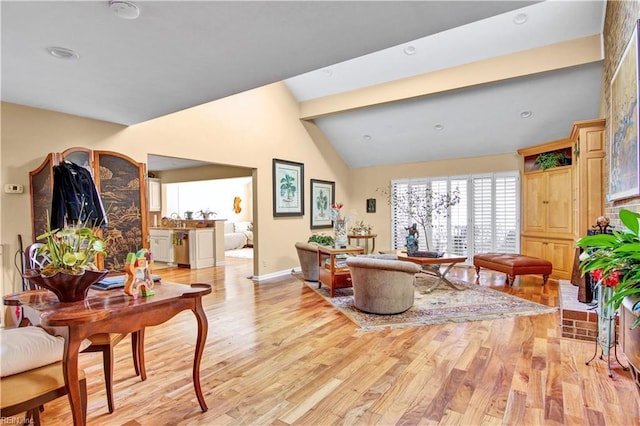 living room featuring sink, vaulted ceiling, and light wood-type flooring