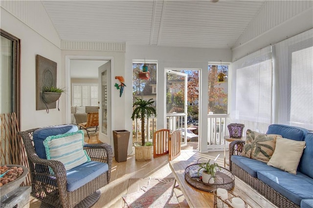 sunroom with lofted ceiling and a healthy amount of sunlight