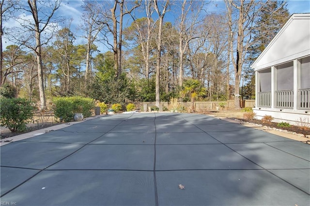 view of swimming pool featuring a sunroom