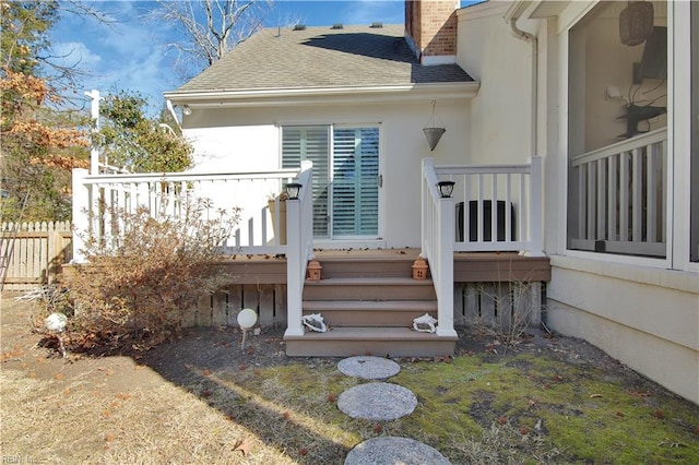 view of exterior entry featuring a deck