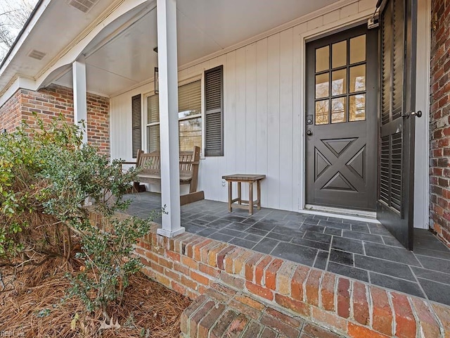 entrance to property featuring a porch