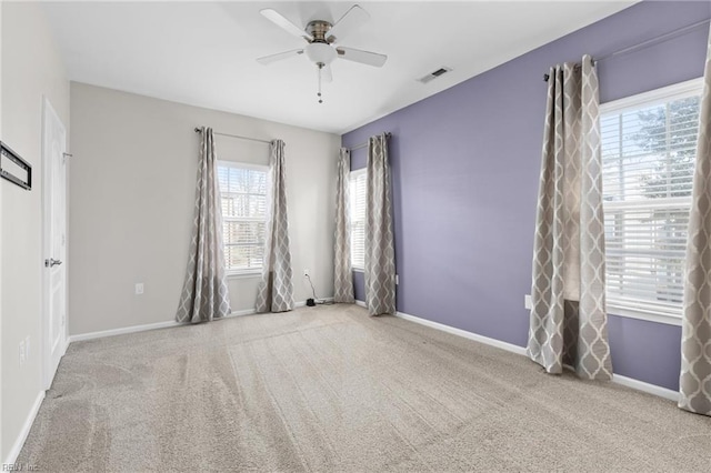 empty room with light colored carpet and ceiling fan