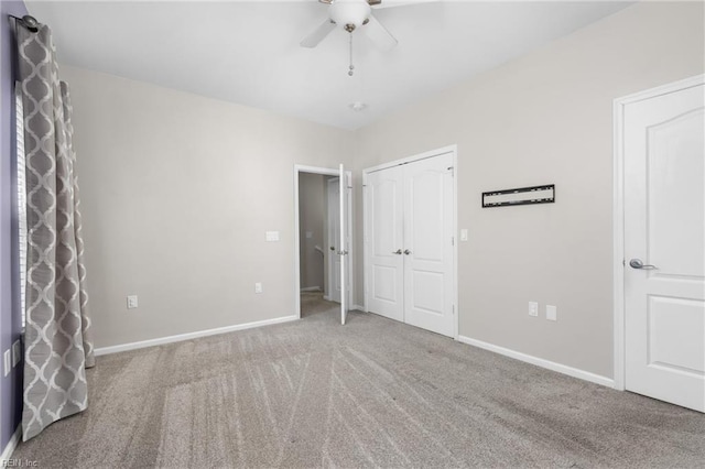 unfurnished bedroom featuring carpet, ceiling fan, and a closet