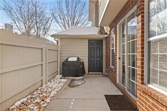 snow covered patio featuring area for grilling