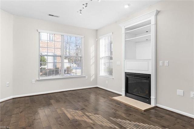 unfurnished living room with dark hardwood / wood-style floors