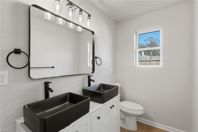 bathroom featuring vanity, hardwood / wood-style floors, and toilet