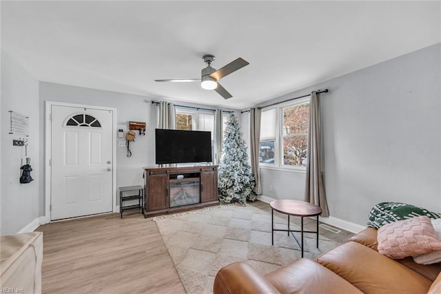 living room featuring ceiling fan and light wood-type flooring