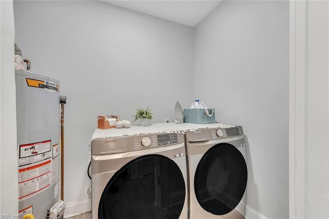 clothes washing area featuring washer and clothes dryer and gas water heater