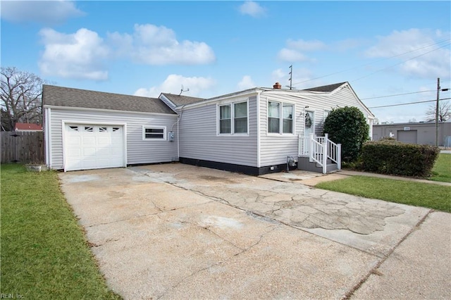 view of front of property featuring a garage and a front lawn