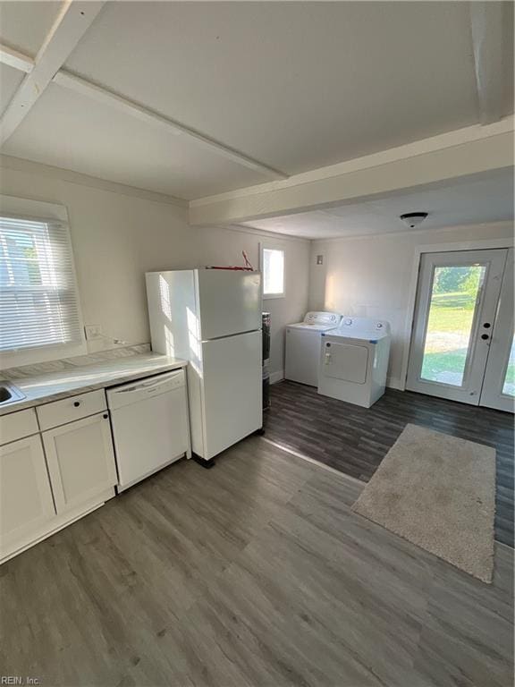 kitchen featuring hardwood / wood-style floors, white appliances, washer and dryer, and white cabinets